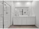 Contemporary bathroom with glass shower and double sink vanity, featuring sleek white finishes at 9715 Harper Edge St, Las Vegas, NV 89143