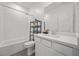Clean bathroom with a shower-tub combo, white vanity, and modern fixtures at 9715 Harper Edge St, Las Vegas, NV 89143