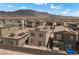 View of the back of a home with a small in-ground pool and solar panels on the roof at 9715 Harper Edge St, Las Vegas, NV 89143