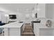 Modern kitchen with white cabinets, an island with seating, and stainless steel appliances at 9715 Harper Edge St, Las Vegas, NV 89143