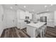 Modern kitchen with white cabinets, stainless steel appliances and a breakfast bar featuring seating at 9715 Harper Edge St, Las Vegas, NV 89143