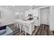 Bright kitchen with an island, white cabinets, stainless appliances and barstool seating at 9715 Harper Edge St, Las Vegas, NV 89143