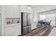 Modern kitchen with stainless steel appliances, white cabinetry, and an adjacent dining area at 9715 Harper Edge St, Las Vegas, NV 89143