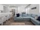 Bright living room features an open floor plan and comfortable blue sectional sofa at 9715 Harper Edge St, Las Vegas, NV 89143