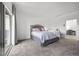Bright main bedroom featuring a king bed, neutral colors, and a door leading to another room at 9715 Harper Edge St, Las Vegas, NV 89143