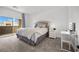 Bright main bedroom with a walk out balcony and a vanity area for getting ready at 9715 Harper Edge St, Las Vegas, NV 89143