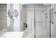 Bright bathroom with a glass-enclosed shower with built-in seating and grab bar at 10245 S Maryland Pkwy # 106, Las Vegas, NV 89183