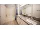 Well-lit bathroom boasts double sinks, granite countertops, and a separate tub and shower at 10245 S Maryland Pkwy # 106, Las Vegas, NV 89183