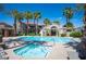 Resort-style community pool and spa are surrounded by palm trees for relaxation at 10245 S Maryland Pkwy # 106, Las Vegas, NV 89183