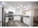 Contemporary kitchen featuring stainless steel appliances, a peninsula, and a bright, open design at 10245 S Maryland Pkwy # 106, Las Vegas, NV 89183