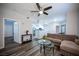 Bright living room with contemporary decor, modern ceiling fan, and seamless flow to the kitchen at 10245 S Maryland Pkwy # 106, Las Vegas, NV 89183