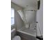 A clean bathroom featuring a shower with a shower curtain, and white tiled walls at 1050 Spotted Saddle St, Henderson, NV 89015