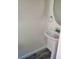 A bathroom featuring a pedestal sink, chrome faucet and wood-look tile flooring at 1050 Spotted Saddle St, Henderson, NV 89015