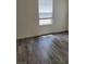 Bright bedroom featuring wood-style flooring and a window that allows for natural light at 1050 Spotted Saddle St, Henderson, NV 89015
