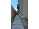 Narrow side yard of home with walkway at 1050 Spotted Saddle St, Henderson, NV 89015