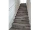 A view of stairs with wood flooring and a white handrail in a well-lit hallway at 1050 Spotted Saddle St, Henderson, NV 89015