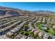 Expansive aerial view of a beautiful neighborhood with mountain views and community pool at 10693 Harvest Green Way, Las Vegas, NV 89135