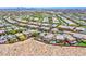 This aerial view shows a desert community with pools and other backyard amenities at 10693 Harvest Green Way, Las Vegas, NV 89135