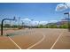 Outdoor basketball court with multiple hoops providing ample space for games and practice, surrounded by lush greenery at 10693 Harvest Green Way, Las Vegas, NV 89135