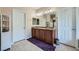 Bathroom with double sinks, vanity and plenty of storage space, and tiled floors at 10693 Harvest Green Way, Las Vegas, NV 89135