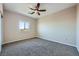 This bedroom features neutral colored walls, carpeted floors, a ceiling fan, and a window at 10693 Harvest Green Way, Las Vegas, NV 89135