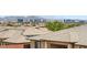 View of the city skyline from a rooftop with terracotta tile and lush greenery at 10693 Harvest Green Way, Las Vegas, NV 89135