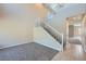 Open entryway with high ceilings, staircase, and tile and carpet flooring at 10693 Harvest Green Way, Las Vegas, NV 89135