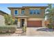 Two-story home with a two-car garage, desert landscaping, and a brick driveway at 10693 Harvest Green Way, Las Vegas, NV 89135