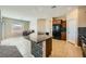 Open kitchen area with a large island, stainless steel appliances, and tile flooring at 10693 Harvest Green Way, Las Vegas, NV 89135