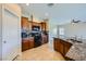 View of kitchen with stainless steel appliances, granite countertops, and tile flooring at 10693 Harvest Green Way, Las Vegas, NV 89135