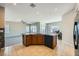 Open-concept kitchen with a central island, modern appliances, and dining area at 10693 Harvest Green Way, Las Vegas, NV 89135