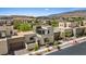 Aerial view showcasing the property's sleek exterior, professional landscaping, and proximity to the neighborhood amenities at 10895 Artesano Ave, Las Vegas, NV 89135