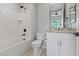 Well-lit bathroom featuring a tub-shower combo, a toilet, and a vanity with storage at 10895 Artesano Ave, Las Vegas, NV 89135