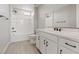 Bright bathroom featuring a shower-tub combo, white cabinets, and modern fixtures at 10895 Artesano Ave, Las Vegas, NV 89135