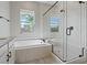 Modern bathroom featuring soaking tub, glass shower and sleek black hardware accents at 10895 Artesano Ave, Las Vegas, NV 89135