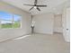 Spacious bedroom with large window, plush carpeting, and modern lighting fixtures at 10895 Artesano Ave, Las Vegas, NV 89135