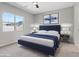 Modern bedroom featuring a plush blue bed, stylish decor, and a serene atmosphere for restful nights at 10895 Artesano Ave, Las Vegas, NV 89135