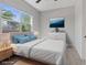 Serene bedroom with soft blue accents, large window, and minimalist decor for a peaceful retreat at 10895 Artesano Ave, Las Vegas, NV 89135