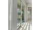 Hallway leading to sliding glass doors showcasing great natural light and neutral finishes at 10895 Artesano Ave, Las Vegas, NV 89135