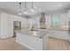 Bright kitchen featuring a large island, stainless steel appliances, white cabinets, and sleek countertops at 10895 Artesano Ave, Las Vegas, NV 89135