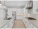 Modern kitchen with stainless appliances, a large island, white cabinets, and an adjacent dining area with seating for six at 10895 Artesano Ave, Las Vegas, NV 89135