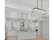 Modern kitchen boasts sleek countertops, stainless steel appliances, and ample natural light from surrounding windows at 10895 Artesano Ave, Las Vegas, NV 89135