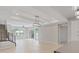 Expansive living area with light flooring, modern staircase, and sliding doors to bring the outdoors inside at 10895 Artesano Ave, Las Vegas, NV 89135