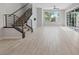 Bright living area with staircase, large window, and sliding glass doors, complete with modern finishes at 10895 Artesano Ave, Las Vegas, NV 89135