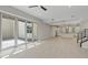 Open-concept living space boasts sleek tile floors, a modern staircase, and seamless access to the outdoor patio at 10895 Artesano Ave, Las Vegas, NV 89135