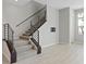 Modern staircase features sleek railings and wood trim, with light-colored walls and tile flooring at 10895 Artesano Ave, Las Vegas, NV 89135