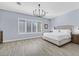 Spacious bedroom with large windows, chandelier, and light wood flooring at 11 Feather Sound Dr, Henderson, NV 89052