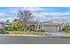 Charming single-story home with manicured lawn, mature trees, and attached garage at 11 Feather Sound Dr, Henderson, NV 89052