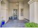 Covered front porch with tile flooring, decorative door, and seating at 11 Feather Sound Dr, Henderson, NV 89052