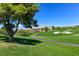 Lush green golf course with a winding path and mountain views at 11 Feather Sound Dr, Henderson, NV 89052